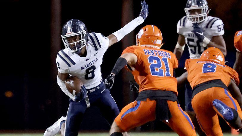 Marietta wide receiver Zuri Johnson (8) makes a move after a catch in the first half of Friday's game against Parkview.