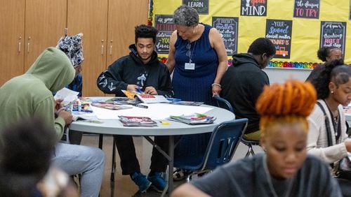 Redan High School FACE advocate Gail Jones (right) helps Christian Abram with his vision board during an end-of-year group project in Stone Mountain on Tuesday, May 14, 2024. (Steve Schaefer / AJC)