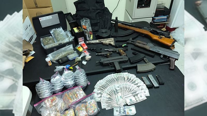 Guns, drugs and cash were found when authorities raided a Rockdale County home. (Credit: Channel 2 Action News)