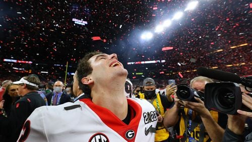Stetson Bennett relishes the moment as the confetti flies after Georgia won the College Football Playoff Championship game on Monday in Indianapolis. (Curtis Compton/curtis.compton@ajc.com)