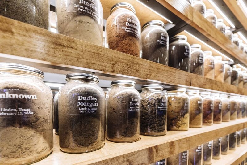 Hundreds of jars of soil from documented lynching sites are arranged on shelves at the memorial. (Audra Melton/The New York Times)
