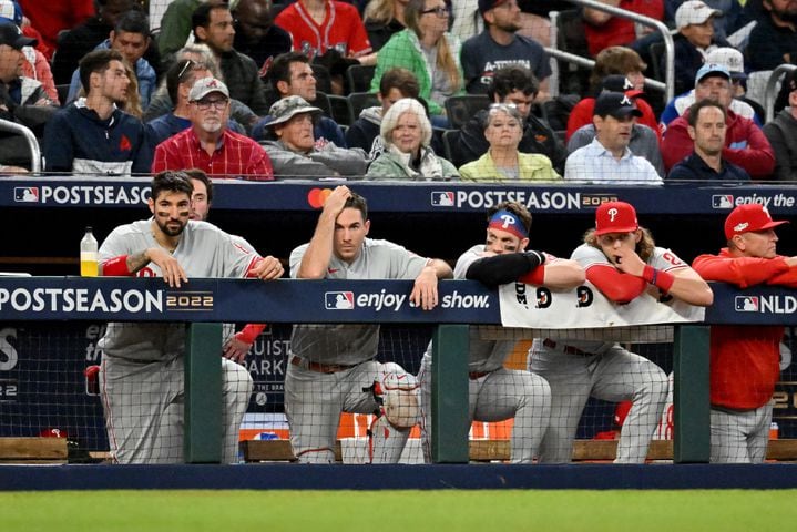 Philadelphia Phillies players watch from the dugout during the eighth inning of game two of the National League Division Series against the Atlanta Braves at Truist Park in Atlanta on Wednesday, October 12, 2022. (Hyosub Shin / Hyosub.Shin@ajc.com)