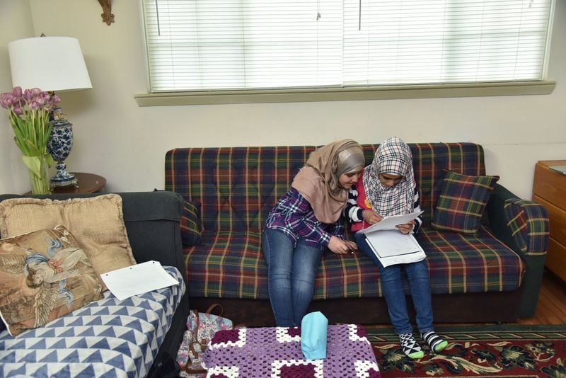 Nor Alhoda Musa (left), 12, and Reem Musa, 11, study together at their Clarkston apartment on April 13, 2017. HYOSUB SHIN / HSHIN@AJC.COM