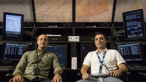 Air traffic control specialists James Hossenlopp, 36, (left) and Jason Harvey, 35, pose for a portrait in the Testing and Training Lab at the Atlanta Air Route Traffic Control Center in Hampton, Georgia, on Friday, Oct. 27, 2017. (CASEY SYKES / CASEY.SYKES@AJC.COM)