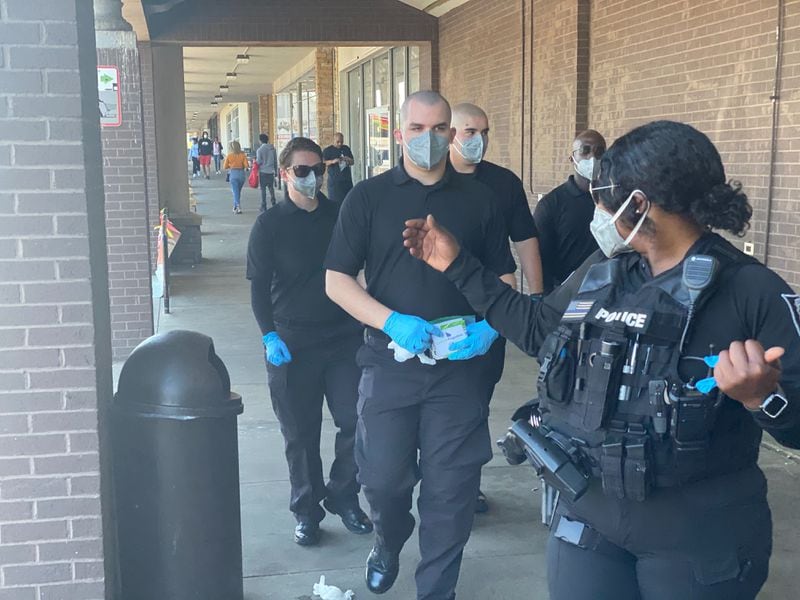 DeKalb County Police and Fire Rescue cadets and trainees handed out face masks and hand sanitizers to residents on Saturday, May 2, 2020, at Kroger Plaza on Memorial Drive in Decatur. The initiative is expected to run six weeks with 10,000 masks to be given to those in need. (Photo: Roderic Graham/AJC)
