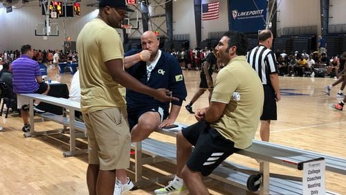 Georgia Tech coach Josh Pastner (seated right) converses with assistant coaches Anthony Wilkins (standing) and Julian Swartz (seated left) at the Georgia Basketball Coaches Association team camp at the LakePoint Sports complex in Emerson on June 18, 2021. (AJC photo by Ken Sugiura)