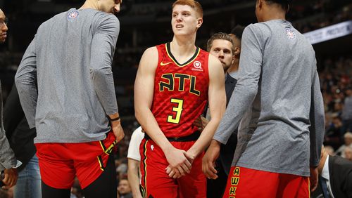 Atlanta Hawks guard Kevin Huerter holds his arm after an injury during the second half of the team's NBA basketball game agains the Denver Nuggets on Tuesday, Nov. 12, 2019, in Denver. Atlanta won 125-121. (AP Photo/David Zalubowski)