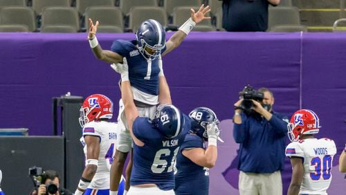 Georgia Southern quarterback Shai Werts (1) is lifted up after scoring a touchdown against Louisiana Tech during the first half of the New Orleans Bowl Wednesday, Dec. 23, 2020, in New Orleans. (Matthew Hinton/AP)