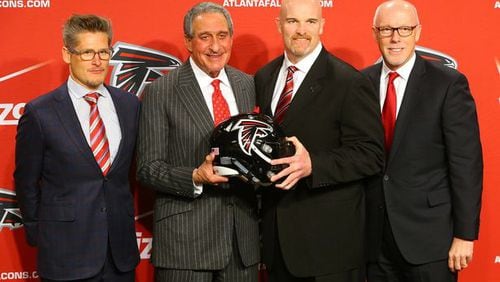 General manager Thomas Dimitroff (from left), owner Arthur Blank, coach Dan Quinn and President and CEO Rich McKay pose for a photo at the end of a news conference introducing Quinn as coach on Feb. 3 in Flowery Branch. Curtis Compton / ccompton@ajc.com