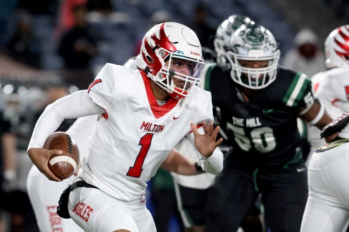 Milton quarterback Devin Farrell (1) runs for yards during the first half against Collins Hill in the Class 7A state title football game at Georgia State Center Parc Stadium Saturday, December 11, 2021, Atlanta. JASON GETZ FOR THE ATLANTA JOURNAL-CONSTITUTION