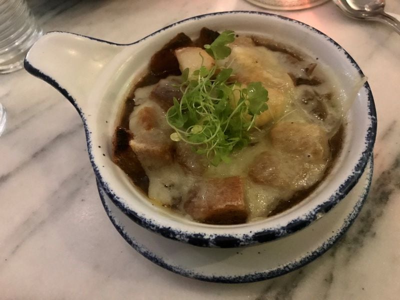 Georgia Onion Soup at City Pharmacy is a solid version of the classic; the beef jus is deeply flavorful, and the measure of melted Gruyere cheese is just right. LIGAYA FIGUERAS / LFIGUERAS@AJC.COM