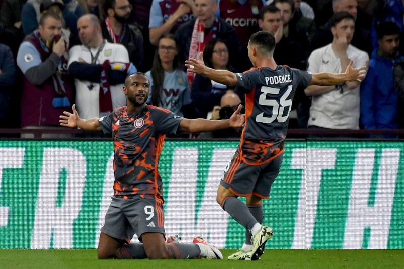 Olympiacos' Ayoub El Kaabi, left, celebrates after scoring his side's second goal during the Europa Conference League semifinal, first leg, soccer match between Aston Villa and Olympiacos at Villa Park in Birmingham, England, Thursday, May 2, 2024. (AP Photo/Rui Vieira)