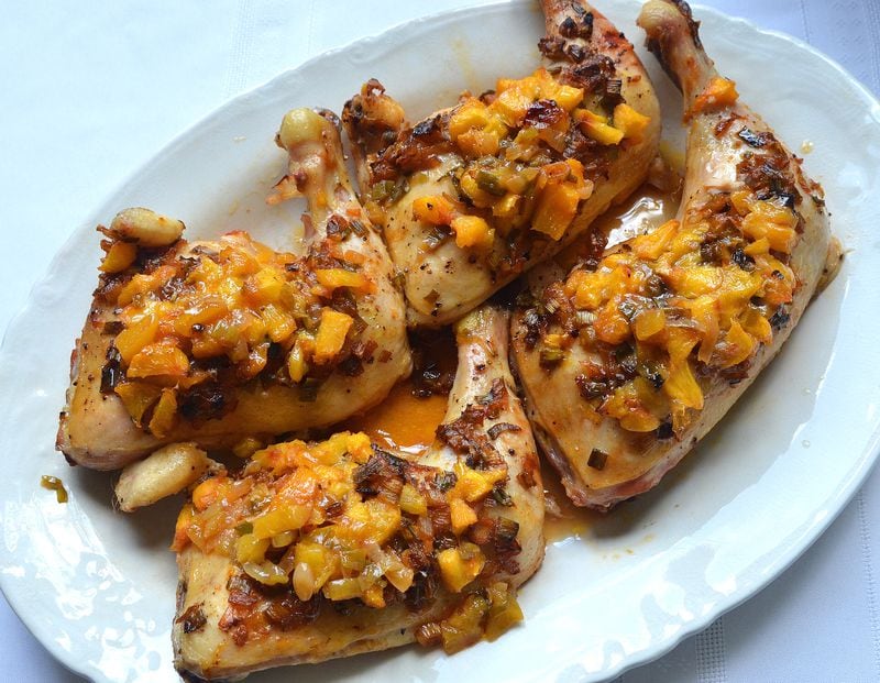 This easy baked-chicken recipe is dressed up with chopped peaches and a splash of bourbon. It's from "Dori Sanders' Country Cooking" (Algonquin, $15.95), by the South Carolina novelist who runs a peach stand at her family's farm in Filbert, S.C. "It is so good. It is almost literally to die for," Sanders says. Styling by Wendell Brock. (Photo by Chris Hunt/Special) 