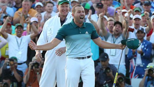Sergio Garcia lets the world knows how he feels after sinking his birdie putt on the first playoff hole Sunday to win the Masters. (Curtis Compton/ccompton@ajc.com)