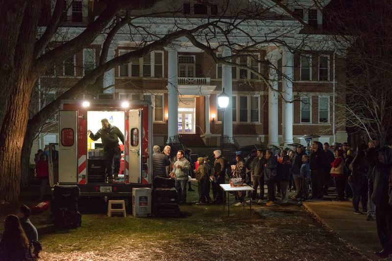 People line up for free snacks and beverages from the Salvation Army on the campus of Asbury University in Wilmore, Ky., on Feb. 18, 2023. The small town of Wilmore has been overwhelmed by visitors. (Jesse Barber/The New York Times)