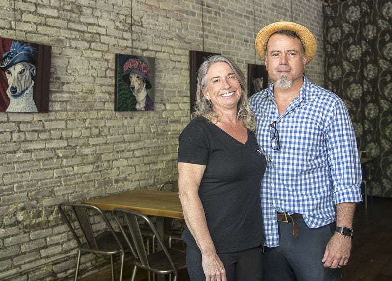 1910 Public House owners Jennifer (left) and Tony Tiberia pose for a photo inside their restaurant in downtown Lilburn. They’ve had to keep shifting the business to deal with the pandemic and metro Atlantans’ concerns about public gatherings. (ALYSSA POINTER / ALYSSA.POINTER@AJC.COM)