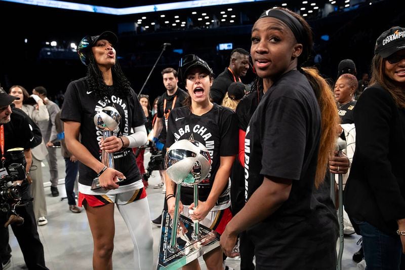 A'ja Wilson, Kelsey Plum and Jackie Young celebrate the second consecutive WNBA championship won by Las Vegas Aces on Oct. 18, 2023. 