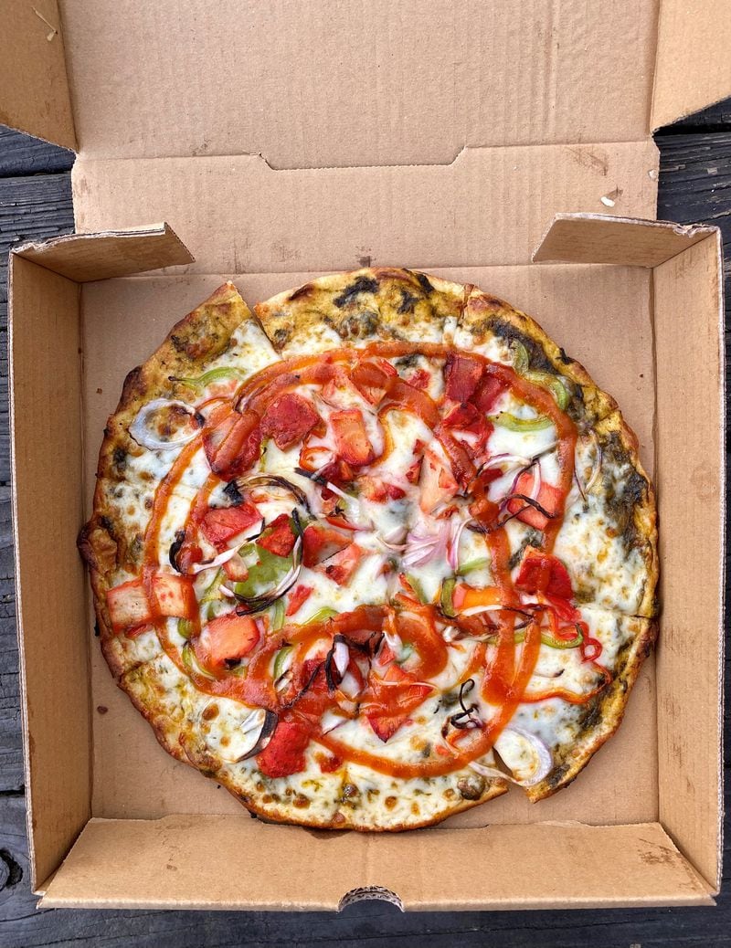 Tandoori Pizza & Wing Co. serves a classic tandoori chicken pizza. At 10 inches, it’s on the smaller side, and sells for $14. Wendell Brock for The Atlanta Journal-Constitution