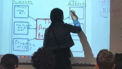 A Northbrook Middle School student takes part in a social studies lesson using an interactive whiteboard. Gwinnett County has invested about $40 million in technology upgrades for middle schools. ARLINDA SMITH BROADY/AJC
