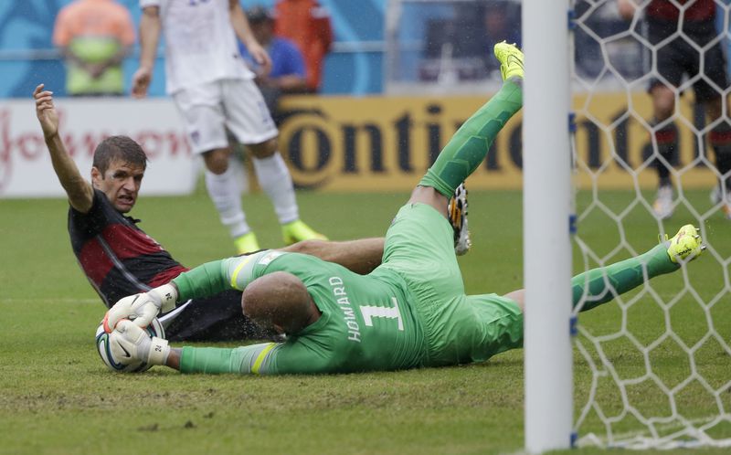 FILE - United States' goalkeeper Tim Howard dives to make a save on Germany's Thomas Mueller during the group G World Cup soccer match between the USA and Germany at the Arena Pernambuco in Recife, Brazil, Thursday, June 26, 2014. Tim Howard will join Tony Meola, Kasey Keller and Brad Friedel on Saturday, May 4, 2024, as modern-era American goalkeepers in the U.S. National Soccer Hall of Fame. (AP Photo/Ricardo Mazalan, File)