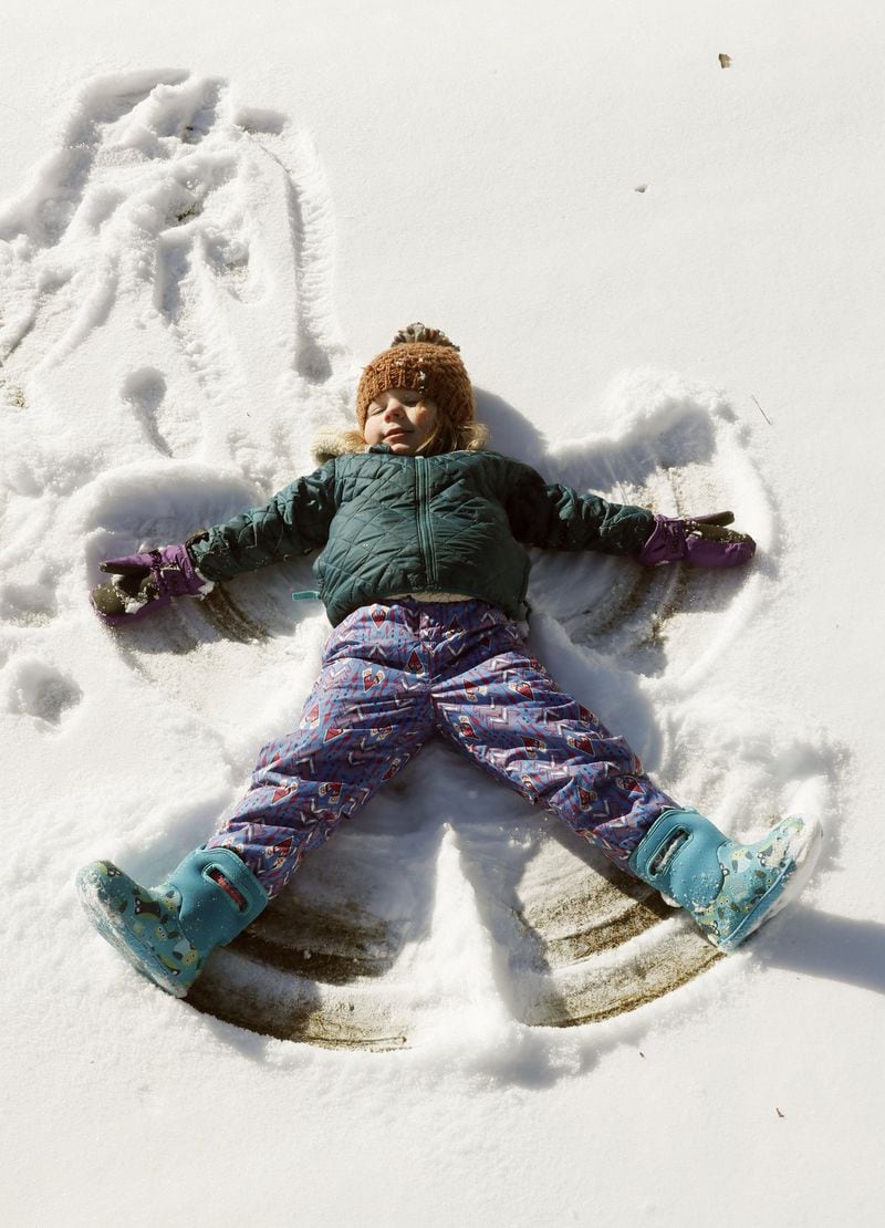 Greer Glover, 3, makes a snow angel at Ansley Golf Club in Atlanta while there with her mother, Melissa. December and January has brought an unusual amount of snow for the metro area. BOB ANDRES /BANDRES@AJC.COM
