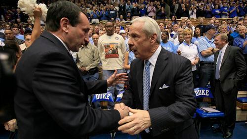 Duke coach Mike Krzyzewski, left, and North Carolina coach Roy Williams saw their programs among those listed in the FBI’s investigation into college basketball.