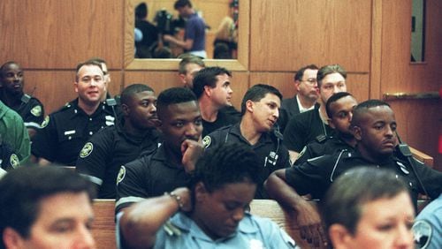 Atlanta Police Officers, sit patiently on Oct. 14, 1997 in Municipal Court in Atlanta, to hear the outcome from the arraignment of Gregory Paul Lawler, then accused of killing one Atlanta police officer and critically wounding another. (AJC Staff Photo/Dwight Ross Jr.) 10/97
