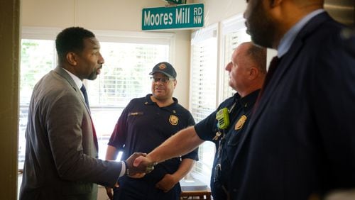 Mayor Andre Dickens (left) shakes hands with Lieutenant Randy McCord (right) while touring Atlanta Fire and Rescue Station 26 on Howell Mill Road in Atlanta on Monday, May 16, 2022. (Arvin Temkar / arvin.temkar@ajc.com)