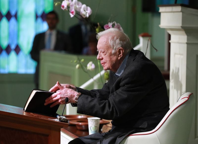 Jimmy Carter opens his Bible to begin the lesson as he returns to Maranatha Baptist Church in Plains less than a month after falling and breaking his hip to teach Sunday school on June 9, 2019.   Curtis Compton/ccompton@ajc.com