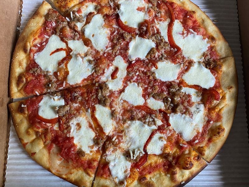 The Two Birds Italian mozz pizza is topped with smoky tomato sauce, house Italian sausage and roasted red peppers. CONTRIBUTED BY BOB TOWNSEND