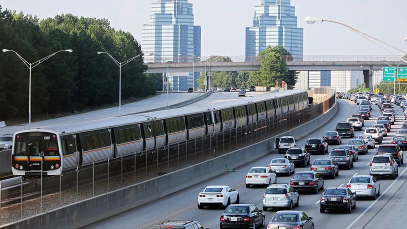 A MARTA train makes its way north past Ga. 400 traffic near Sandy Springs on a typical afternoon rush hour. Ben Gray, bgray@ajc.com