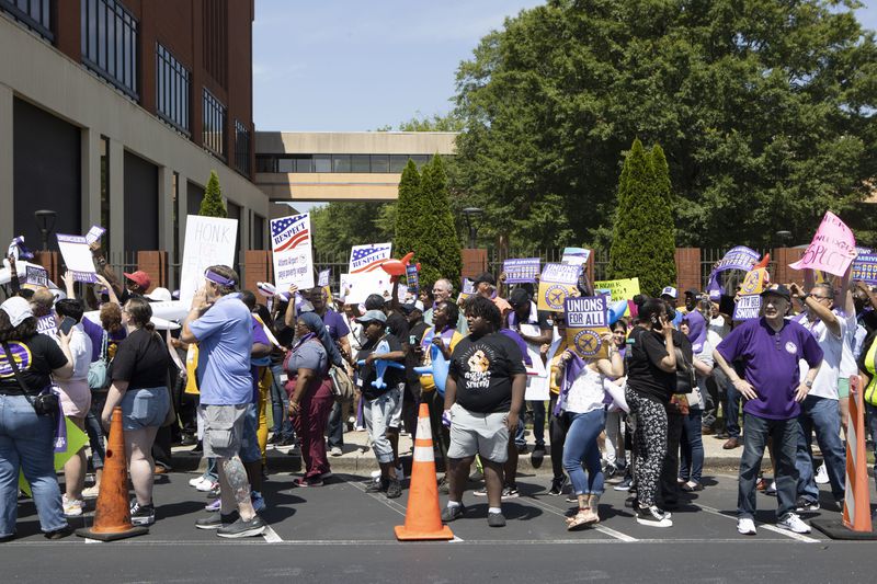 Protesters demonstrate in front of Delta Headquarters during the Airport Workers United march to Delta Headquarters on Saturday, June 3, 2023, in Atlanta. Over 200 protesters marched to demand higher wages. CHRISTINA MATACOTTA FOR THE ATLANTA JOURNAL-CONSTITUTION 