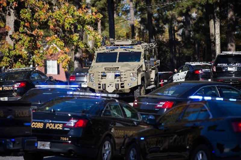 Police vehicles gather the Ridgeview Institute on South Cobb Drive, where a man walked in and opened fire Wednesday. BRANDEN CAMP / SPECIAL