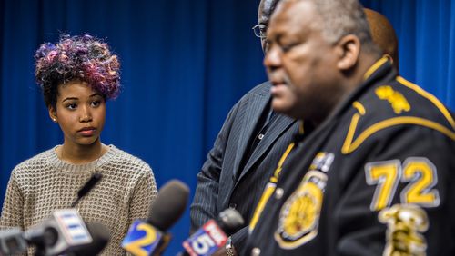 Bridget Anderson (left), the girlfriend of Anthony Hill, listens as Amos King with the Justice for Veterans organization speaks after the DeKalb County District Attorney announced that his office will be seeking a grand jury indictment for Robert Olsen. JONATHAN PHILLIPS / SPECIAL