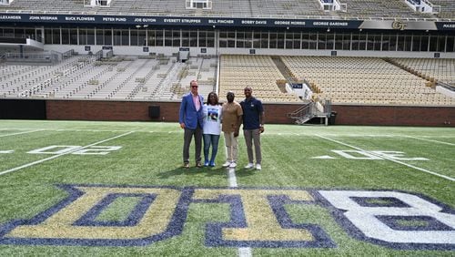 Legendary quarterback Peyton Manning (left) and Georgia Tech great Morgan Burnett (right) pose for a photo with the parents of the late Demaryius Thomas, Katina Smith and Bobby Thomas, at a ceremony at Bobby Dodd Stadium Aug. 8, 2022, to honor the Tech great and Denver Broncos star. (Photo by Danny Karnik/Georgia Tech Athletics)