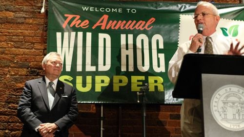 Georgia Gov. Nathan Deal, left, waits to speak as Georgia Agriculture Commissioner Gary Black, introduces him during the 50th annual Wild Hog Supper at the historic Railroad Depot in Atlanta on Jan. 8, 2012.