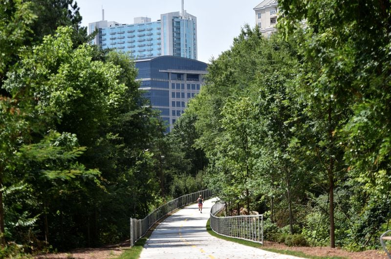 July 2, 2015, Atlanta -- A woman jogs on phase 1 of the PATH400 in Buckhead. The half-mile stretch of multi-use path opened in January 2015. It connects Lenox Road at Tower Place with Old Ivy Road, where another extension north to Wieuca Road opened last year. HYOSUB SHIN / HSHIN@AJC.COM