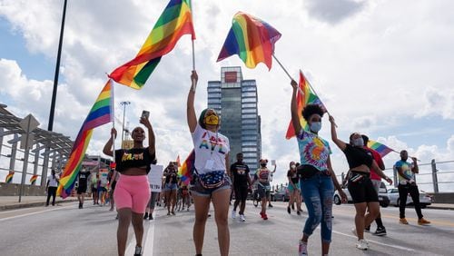 FILE: Dee Dee Tsegaye, from left, Andané Browne and Destiny Britt lead the Beauty In Colors Rally and march across the 17th Street bridge on June 28, 2020. (Photo Courtesy of Ben Gray/Atlanta Journal-Constitution)