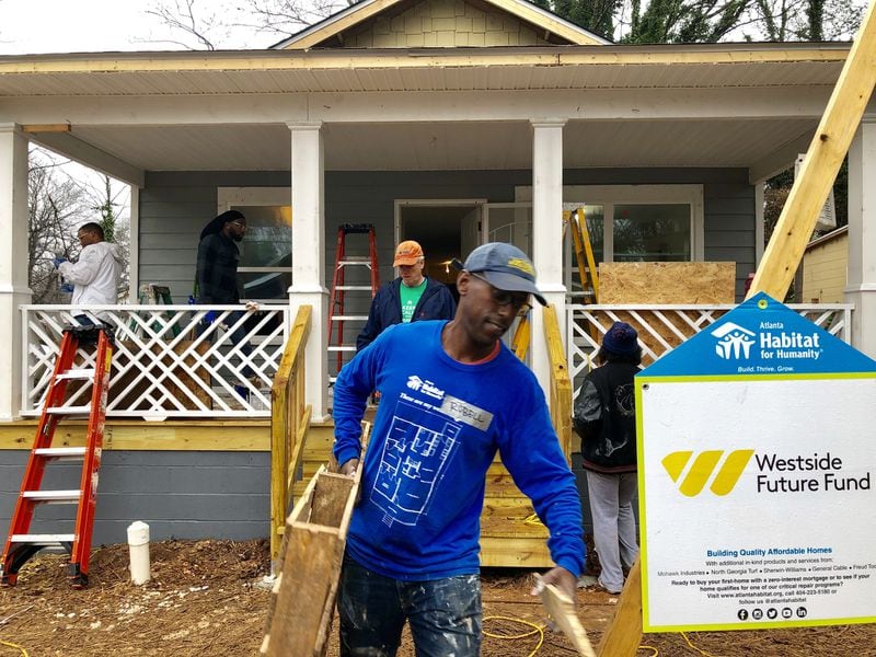 Volunteers work on a Habitat for Humanity home in Atlanta’s Ashview Heights neighborhood near Mercedes-Benz Stadium on Saturday, Jan. 19, 2019. Hundreds of millions of public dollars were committed to the stadium as part of its construction. City leaders, civic groups and Atlanta Falcons owner Arthur Blank have promised to help revitalize neighborhoods in the shadow of the stadium in exchange for that public investment. J. SCOTT TRUBEY/STRUBEY@AJC.COM