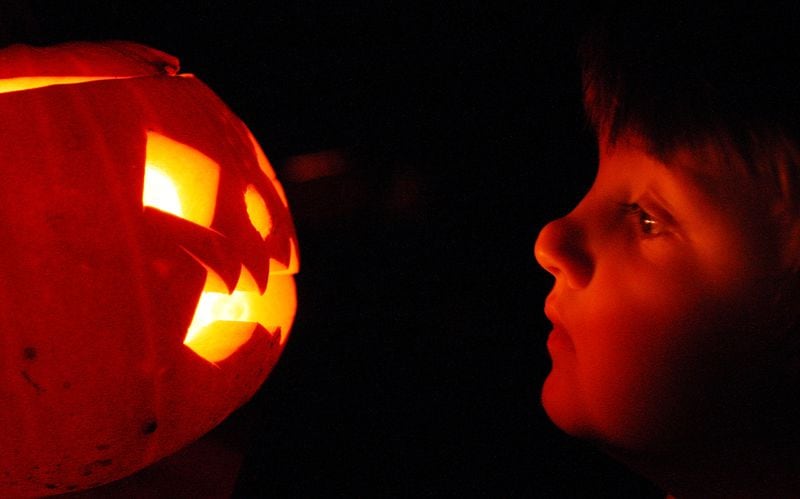 LONDON - OCTOBER 31:  A child enjoys traditional candle-lit Halloween pumpkins on October 31, 2007 in London.  (Photo by Peter Macdiarmid/Getty Images)