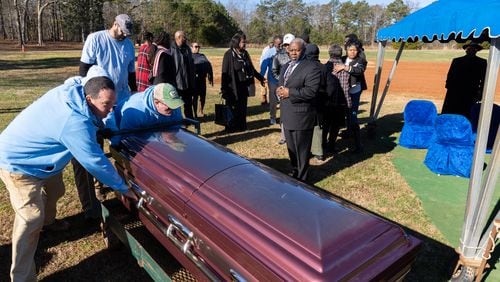 Lakeside Cemetery employees bring the casket of Rodney Daniel, 55, to be buried as part of the Fulton County indigent burial program at Lakeside Cemetery in Palmetto on Thursday, Dec. 28, 2023, following a service for the family. (Arvin Temkar / arvin.temkar@ajc.com)