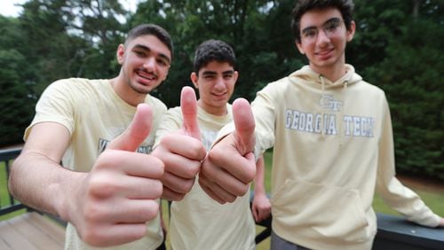 All for one and one for all, the Kashlan triplets Zane (from left), Adam and Rommi are all headed to Georgia Tech, giving the thumbs-up during an interview Tuesday. The brothers were also this year’s valedictorians of West Forsyth High School. CURTIS COMPTON / CCOMPTON@AJC.COM