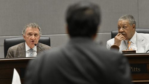 Commissioner Lee Morris (left) questions Michel "Marty" Turpeau IV (foreground), chairman of DAFC, as Commission Chairman Robb Pitts (right) looks during a meeting at the Fulton County government building in Atlanta on Wednesday, July 14, 2021. Michel "Marty" Turpeau IV, chairman of the embattled Development Authority of Fulton County (DAFC), announced Monday he will end his dual role as interim executive director, effective Aug. 31. (Hyosub Shin / Hyosub.Shin@ajc.com)