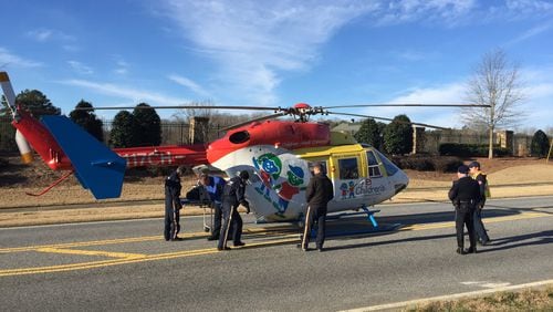 Just before 9:15 a.m., a medical helicopter from Children’s Healthcare of Atlanta at Egleston landed at the scene of a SWAT standoff in a Gwinnett County neighborhood. BRANDEN CAMP/SPECIAL