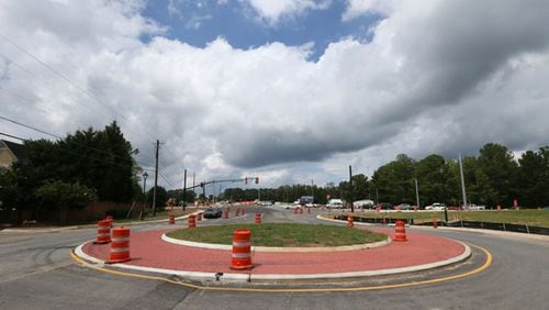 Alpharetta is modifying a roundabout project at Rucker Road and Charlotte Drive by adding a left-turn lane off Rucker to the west. AJC FILE