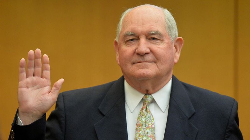 Former Georgia Governor Sonny Perdue is sworn in before his testimony during the APS trial in 2014. (Kent D. Johnson / kdjohnson@ajc.com)