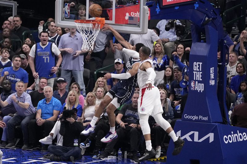 Dallas Mavericks' Josh Green is defended by Los Angeles Clippers' Russell Westbrook, right, on a shot attempt during the first half of Game 2 of an NBA basketball first-round playoff series Friday, April 26, 2024, in Dallas. Russell was called for a flagrant foul on the play. (AP Photo/Tony Gutierrez)