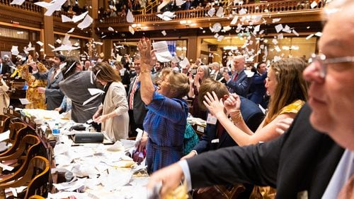 State representatives throw paper in the air to celebrate the end of the legislative session at the House of Representatives in the Capitol in Atlanta on Sine Die, Thursday, March 28, 2024. (Arvin Temkar / arvin.temkar@ajc.com)