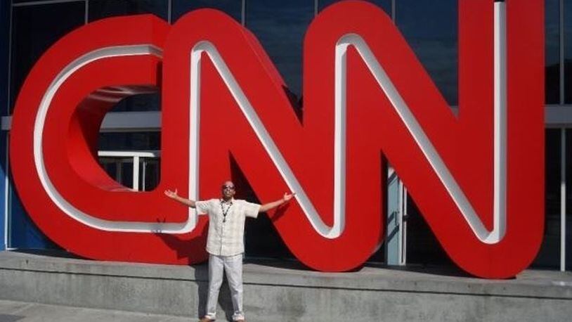Omar Butcher, poising in front of the CNN building in Atlanta, says he was fired after complaining about racially insensitive comments made by an anchor. Contributed