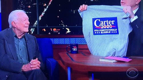 “The Late Show” host Stephen Colbert presents former -- and future? -- President Jimmy Carter with a specially made campaign t-shirt. Courtesy of CBS